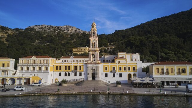 Monastery on the coast with a striking tower, surrounded by forest and mountains, Holy Week, Bay of Panormitis, Panormitis Monastery, Symi, Dodecanese, Greek Islands, Greece