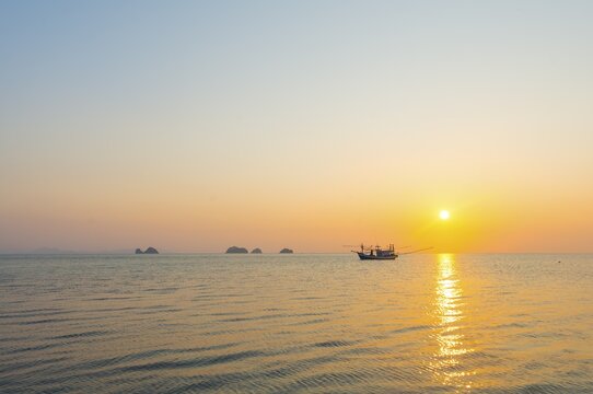 Boat in the sea at sunset in front of small islands, Koh Samui, Gulf of Thailand, Thailand