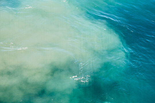 Fuel oil spill in ocean seawater from ship engine, marine pollution, environmental disaster, toxic leakage from vessel motor into sea water.