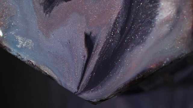 Acrylic spill. Marble ink. Defocused purple orange blue color glitter droplet geometric stone particles on abstract art background.