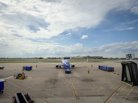 LOUISVILLE, KY, JUN 9, 2026: Head-on view of a Southwest Boeing 737 being pushed back from gate B11, with ground crew, baggage carts, hangars at Louisville Muhammad Ali International Airport