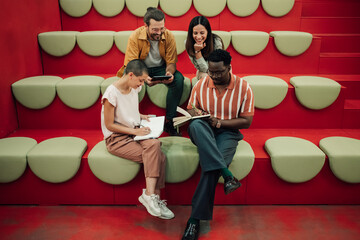 Diverse business team collaborating in creative modern workspace, discussing ideas and planning...