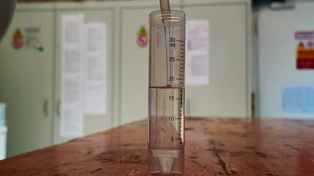 Filling a Plastic Specimen Container with Formalin in a Laboratory