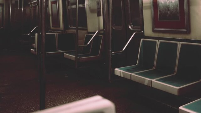 Quietly illuminated subway train cars remain empty as darkness envelops the city. The stillness creates an atmosphere of solitude and reflection, capturing a moment in transit.