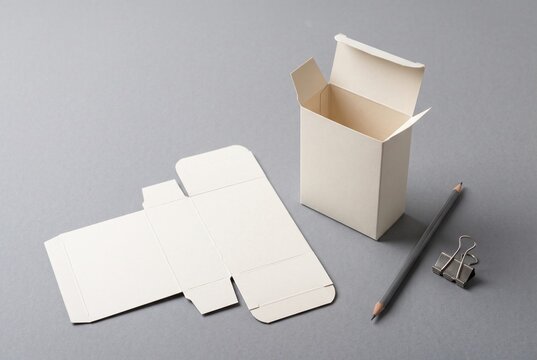 Unprinted folding carton prototype and unfolded blank on designer worktable