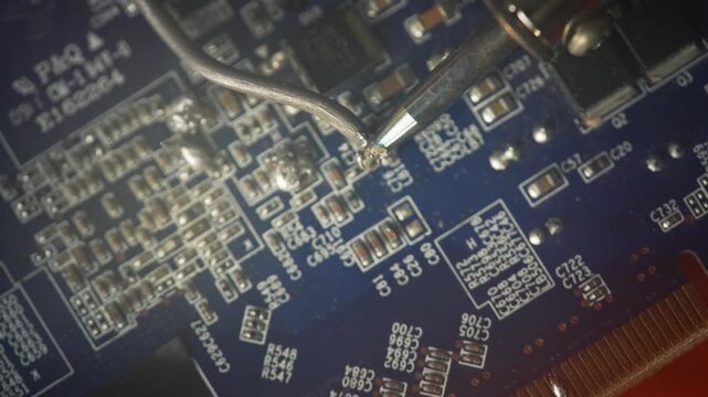 Macro View of Precision Soldering Wire and Heat Tip on Micro Electronic Component