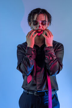 young guy with skull makeup celebrating a Halloween party