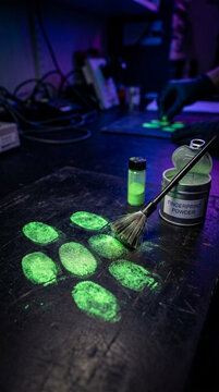 Forensic Fingerprint Powder Glowing Under UV Light Crime Scene Investigation Evidence Collection