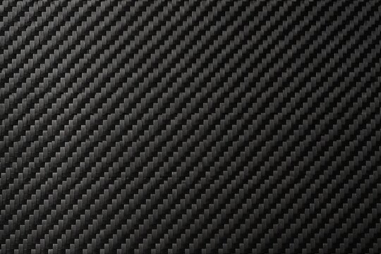 Carbon fiber texture showing diagonal weave on dark surface