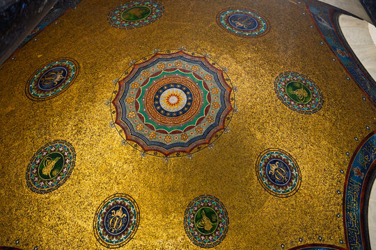 Gilded mosaic ceiling and carved stone base of the German Fountain shown in a wide contextual view in Istanbul, Turkey.