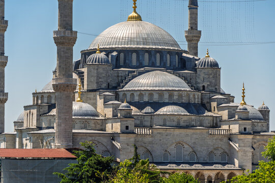 Elevated side-angle view of the Blue Mosque, domes and six minarets above Sultanahmet in Istanbul, Turkey.