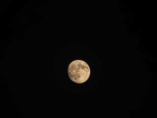 Detailed full moon glowing in the pitch black night sky © Iryna Diadechko