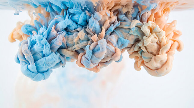 Blue and peach liquid ink clouds dispersing in clear water, creating swirling smoke-like patterns against a white background