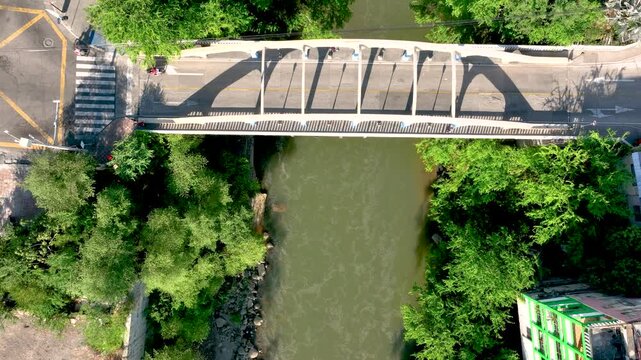 Honda City with Bridges Crossing the Magdalena River in Tolima, Colombia. Establishing Shot. Aerial View.