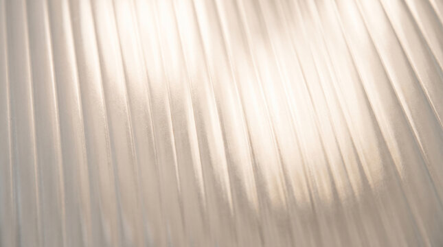 Frosted glass texture with vertical pleats and soft light, symbolizing diffused light, privacy, and subtle elegance, suitable for backgrounds.