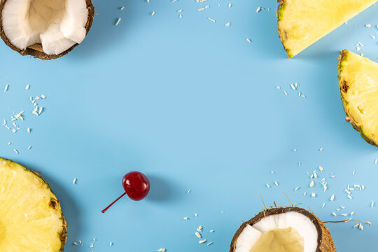 Tropical fruits forming a frame on blue background