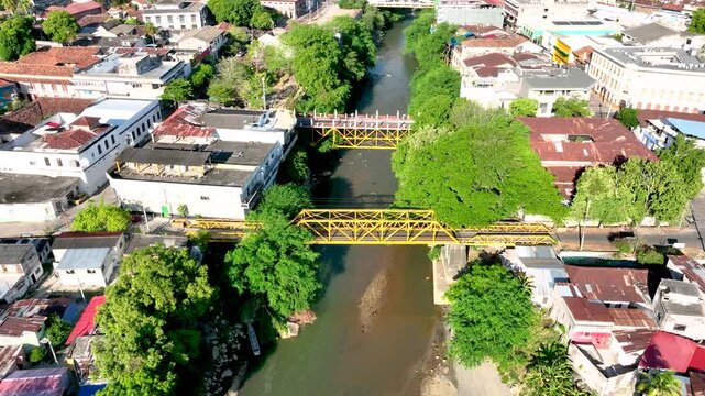 Honda City with Bridges Crossing the Magdalena River in Tolima, Colombia. Establishing Shot. Aerial View.