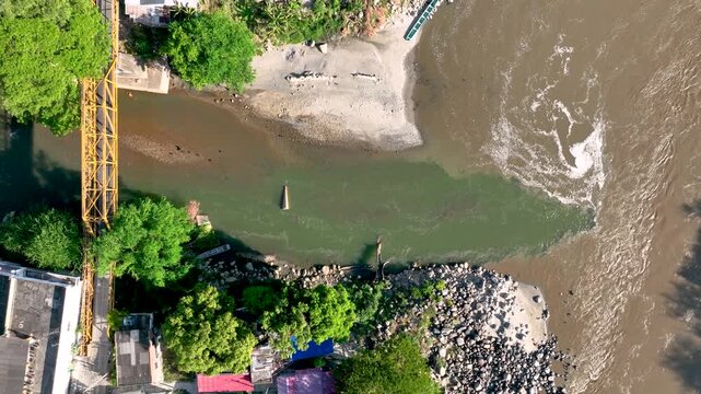 Honda at the Confluence of the Gual&iacute; and Magdalena Rivers with Contrasting Water Colors in Colombia. Establishing Shot. Aerial View.
