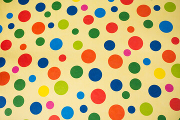 Top-Down View of Colorful Polka Dot Pattern on Light Background © Claudio Bórquez
