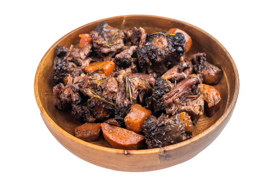 Homemade veal oxtail ragout in wooden bowl, gelatin rich slow cooked meat with vegetables, overhead food photo