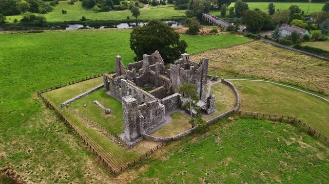 Aerial orbit around Bective Abbey revealing the historic ruins and surrounding landscape, Ireland