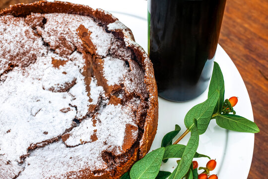 Chocolate Torte Dusted with Sugar and Oporto Port Wine Bottle