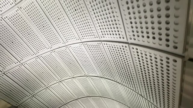 Abstract shot of panels above an escalator as camera moves down, useful for background and copy space 