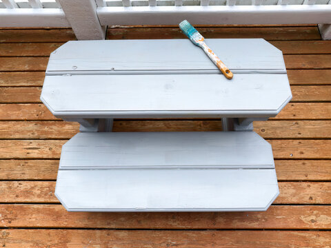 Top view of wood bench step freshly painted for outdoor use on a home deck patio
