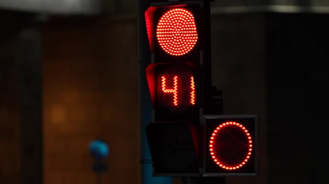 Red traffic signal with illuminated digital countdown timer at an urban intersection, representing road safety, traffic control, driving rules and intelligent city infrastructure