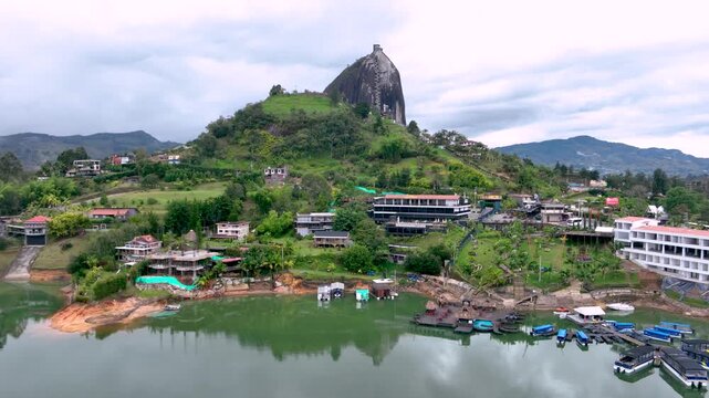 Guatap&eacute; with Piedra del Pe&ntilde;ol Rising Above the Reservoir in Antioquia, Colombia. Establishing Shot. Aerial View.