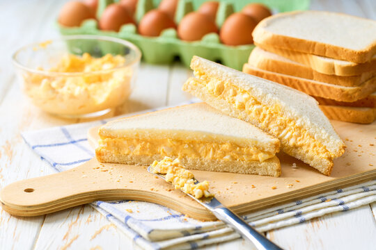 freshly made egg salad sandwiches on a white table, selective focus.