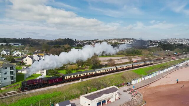Steam Train over Goodrington Beach from a drone, Paignton, Devon, England, United Kingdom