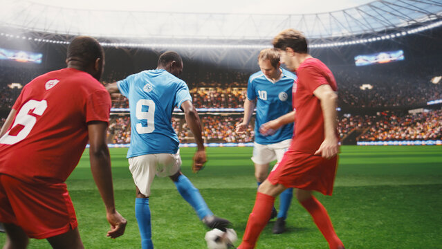 Striker runs forward and kicks a soccer ball to score, using dynamic footwork to break away from an opponent during fast attacking action on the pitch.