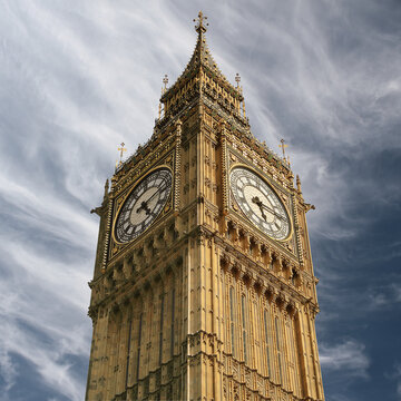 Close-up of the top of Big Ben against a partly cloudy blue sky, London, England, UK
