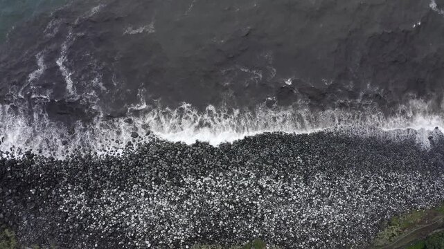 Drone shot, from above, coast with large round stones in Rocha da Relva, Sao Miguel Island, Azores, Portugal