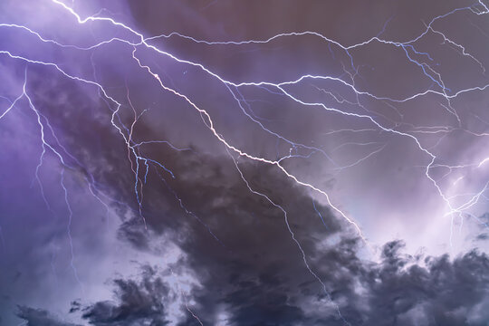 Dramatic Lightning Bolts Striking Across Dark Stormy Night Sky A stormy sky with lightning in the background