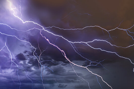 Dramatic Lightning Bolts Striking Across Dark Stormy Night Sky A stormy sky with lightning in the background