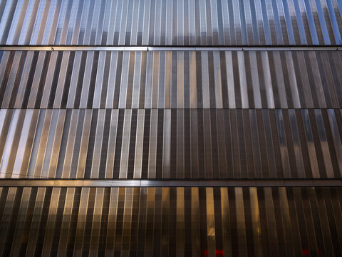 New York City, New York &ndash; October 3, 2026: Vertical metal louvers in sunlight and shadow on the facade of an office building in Lower Manhattan at the World Trade. Center.
