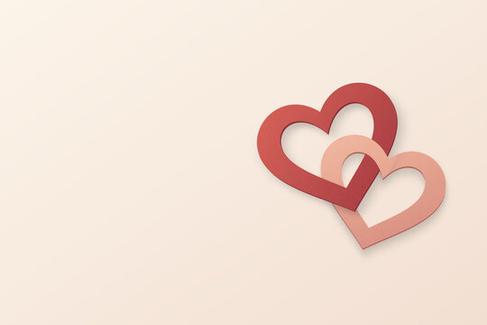 Interlocking red and blush paper hearts with copy space