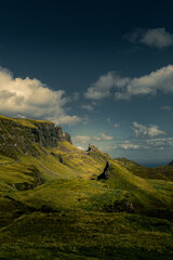 Skye's dramatic cliffs rise under moody clouds. Green hills slope down to rocky outcrops. Vast open landscape feels wild and untouched. Perfect for travel, adventure, or nature themes. Ideal for websi © isabella