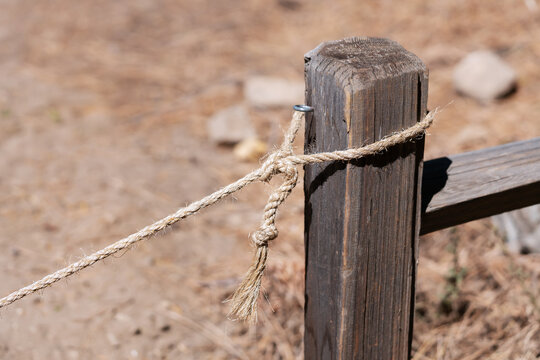 Hemp Rope Tied to Rustic Wooden Fence Post