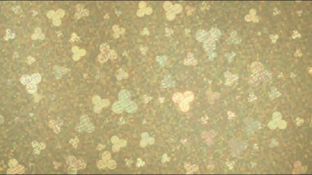 Golden playing card suit patterns gently falling on textured parchment with subtle movement