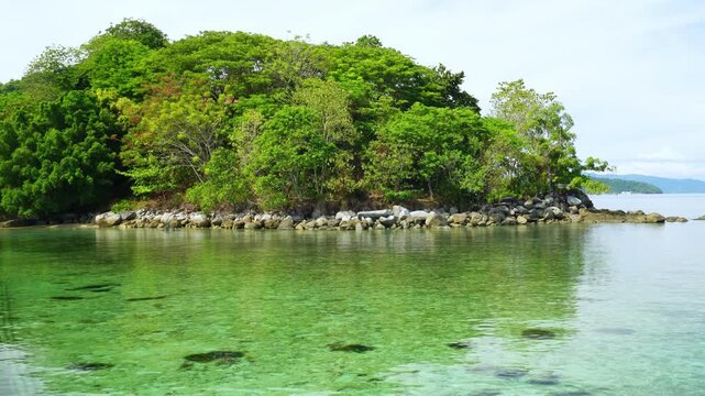 Small Green Islet in Clear Lagoon