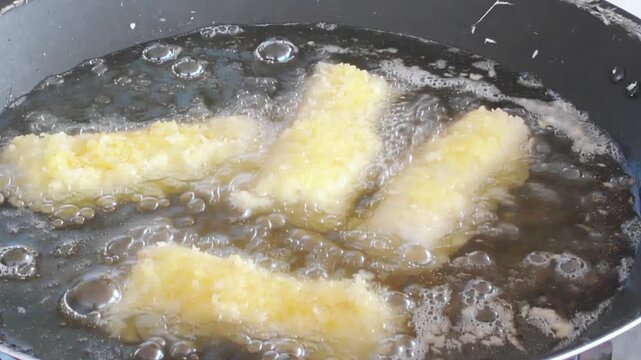 Pot with hot oil during cooking by frying spring rolls