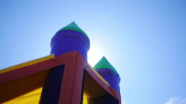 Cinematic Sunlight Poking Through Moving Bounce House