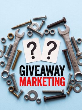 Close-up photo of assorted metal screws, nuts, bolts, and two wrenches around question mark cards with giveaway and &nbsp;red