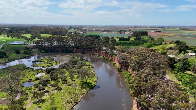 Aerial drone view of Werribee River in Werribee South, Victoria, Australia. Scenic natural beauty of K Road Cliffs, lush river flats with wetland billabongs, surrounding cultivated agricultural&nbsp;land
