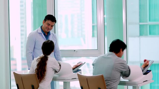 Doctor and patient consultation with medical staff document review at healthcare clinic hospital office, colleagues organizing paperwork near printer in modern administrative workplace