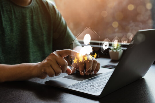 Customer satisfaction feedback concept with person using laptop and touching virtual five star rating interface showing review survey, service quality, user experience and performance analytics