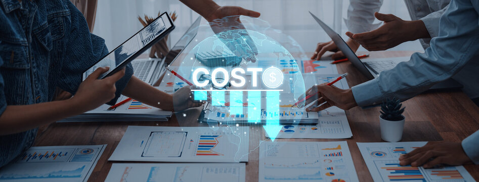 A dynamic business meeting in a modern office environment showcasing hands of professionals discussing cost analysis and financial data with charts on the table. Trope